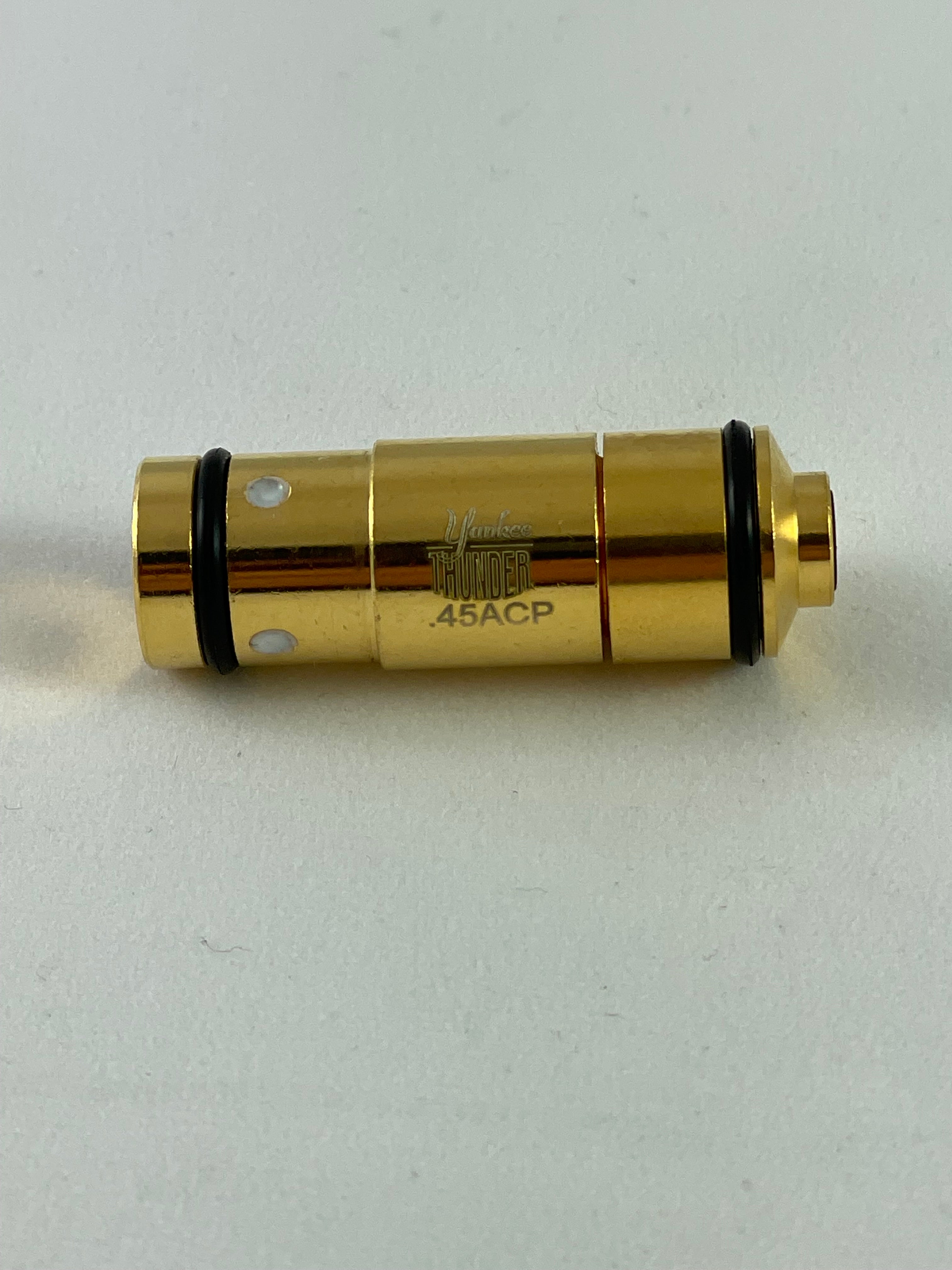 A cylindrical object, gold-colored and labeled 