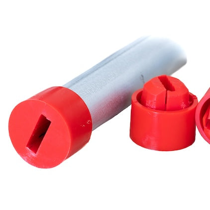 A cylindrical metal object with a red plastic cap on one end and a separate disassembled red plastic cap nearby. Featuring Quick Connect compatibility, the red caps have a rectangular slot and a cross-shaped slot respectively. This innovative product is the 