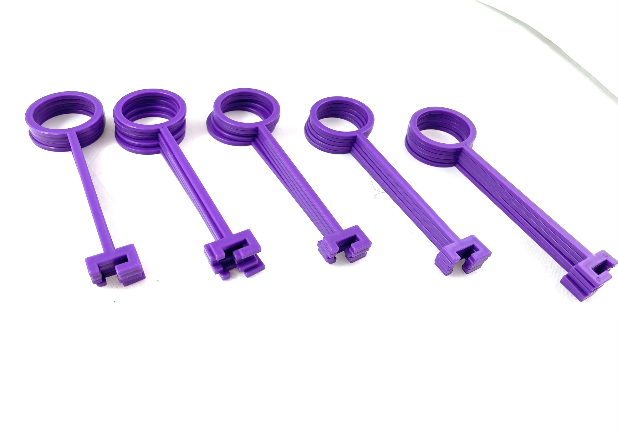 Five identical Purple Clay Pigeon Hooks by Yankee Thunder of varying sizes are arranged in a row on a white background. Each hook, made from durable polymer, features a round handle and a square-ended head.